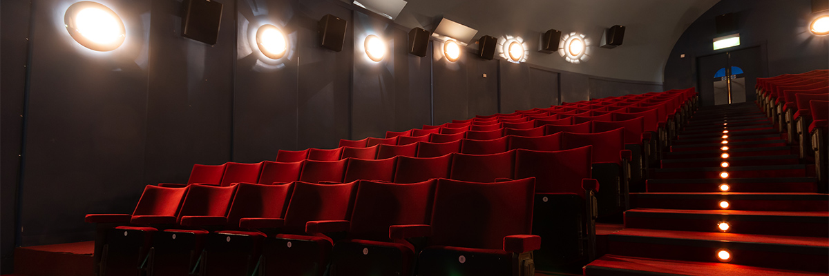 View of the left side of a Pavilion Cinema theater with red seats