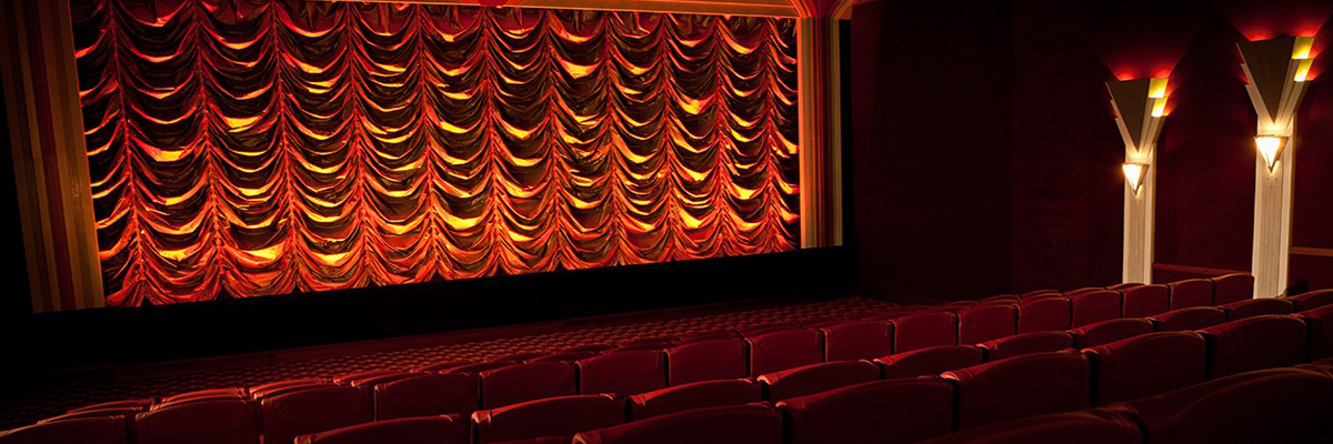 Stage-facing view of the The Roxy Cinema in Wellington with the red curtains closed over the stage