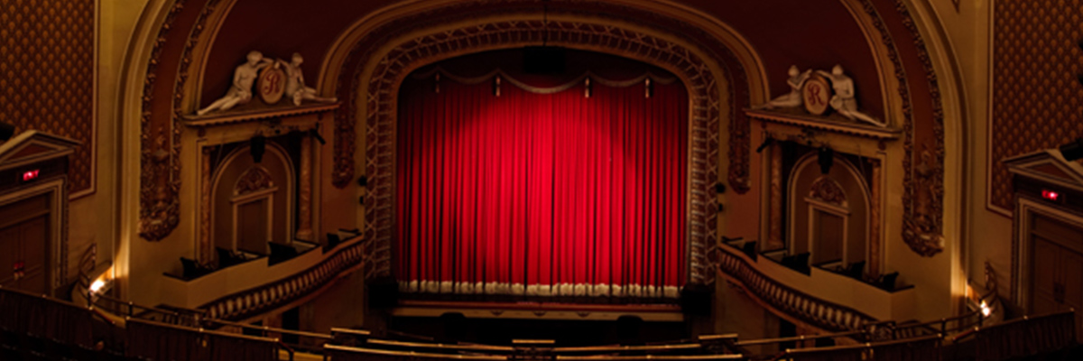 Balcony view of the Royal Theater stage with the red curtains closed