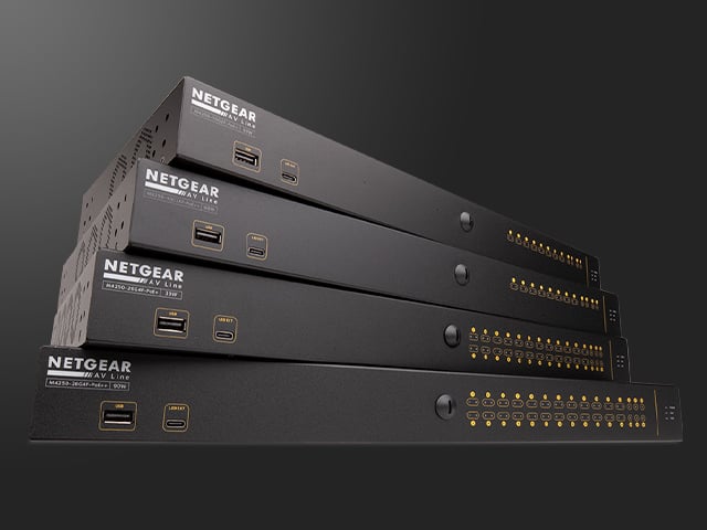 Four Q-SYS NS Series Gen 2 network switches stacked on top of each other